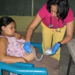 Ana checking a babies heart rate in Las Quebradas