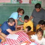 Dr. John Waiits, Teresa Law and Laura Dover praying for a family in Cerro Verde