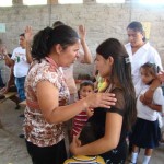 Pastor Margarita praying with a patient
