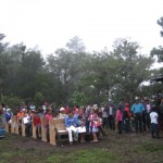 People waiting on church pews outside at Los Ingleses
